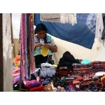 Native woman knitting outside church. Photo by Rick Taylor. Copyright Borderland Tours. All rights reserved.